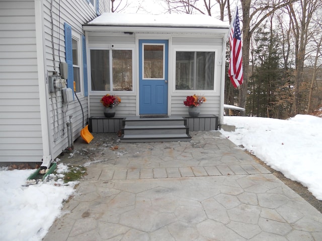 view of snow covered property entrance