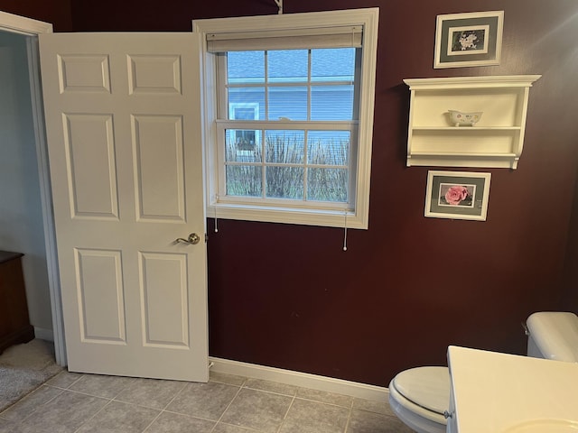 bathroom with tile patterned flooring and toilet