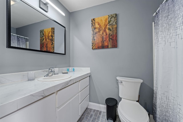 bathroom with tile patterned flooring, vanity, and toilet