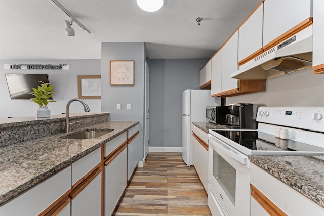 kitchen featuring rail lighting, sink, light hardwood / wood-style flooring, white electric range oven, and white cabinetry