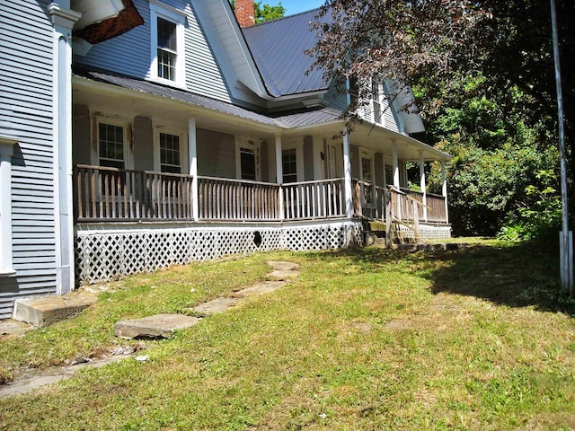 view of home's exterior featuring a yard and covered porch