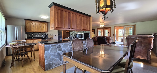 dining area featuring ceiling fan, french doors, and light hardwood / wood-style floors