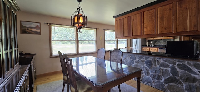 dining area with light hardwood / wood-style floors