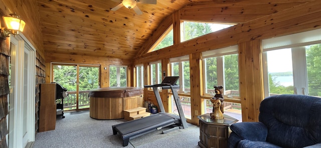 exercise area with wood ceiling, plenty of natural light, light colored carpet, and lofted ceiling