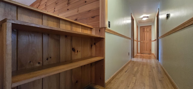 hall featuring light hardwood / wood-style flooring and ornamental molding