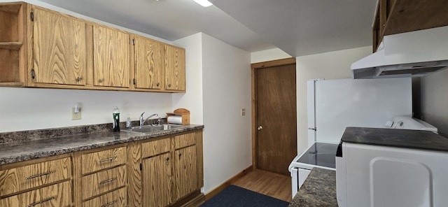 kitchen featuring hardwood / wood-style floors, ventilation hood, white refrigerator, sink, and range