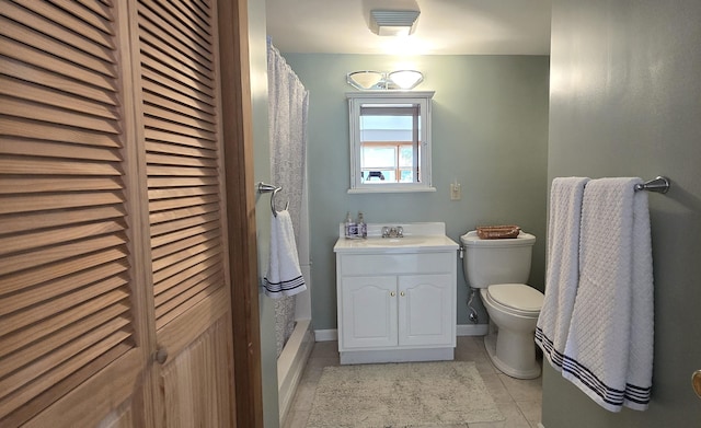 bathroom with tile patterned floors, vanity, and toilet