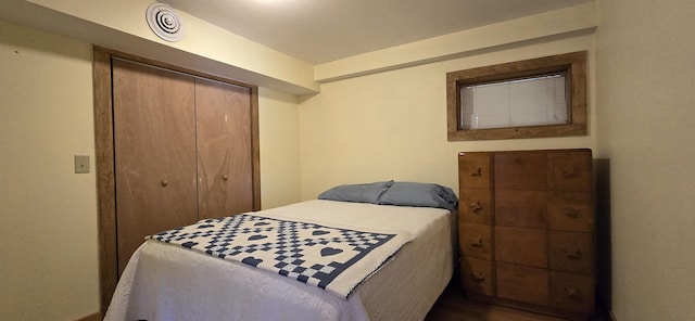 bedroom featuring hardwood / wood-style flooring and a closet