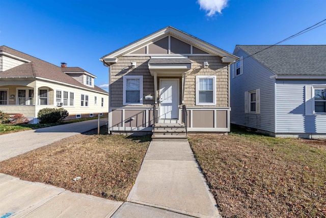 bungalow-style house featuring a front yard