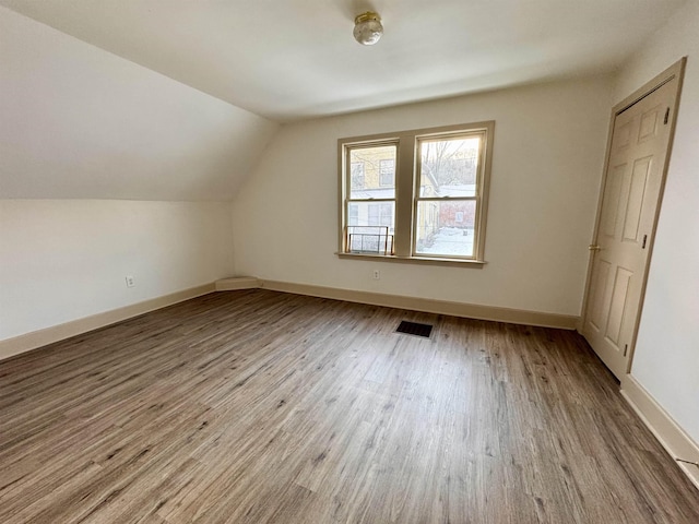 bonus room featuring hardwood / wood-style flooring and lofted ceiling