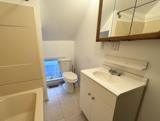 bathroom featuring toilet, vanity, and tile patterned floors