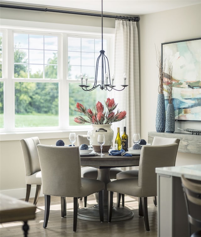 dining area featuring hardwood / wood-style flooring and a notable chandelier