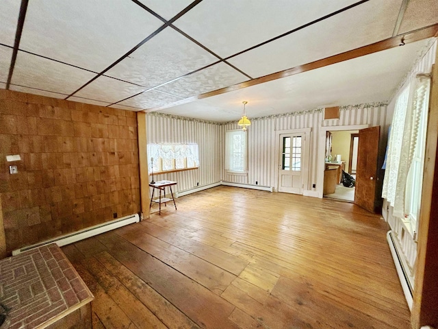 spare room with hardwood / wood-style flooring and a baseboard radiator