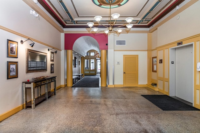 131 Main St Unit 2A-1, Burlington, VT 05401 - foyer entrance featuring elevator, ornate columns, a towering ceiling, a chandelier, and arched walkways