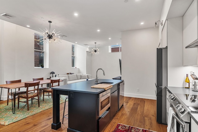 131 Main St Unit 2A-1, Burlington, VT 05401 - kitchen featuring stainless steel appliances, a chandelier, a kitchen island with sink, recessed lighting, and light wood finished floors