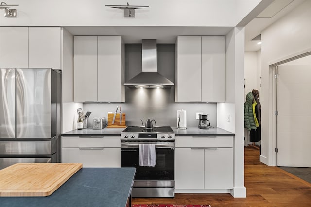 131 Main St Unit 2A-1, Burlington, VT 05401 - kitchen featuring wall chimney exhaust hood, stainless steel appliances, modern cabinets, and white cabinets