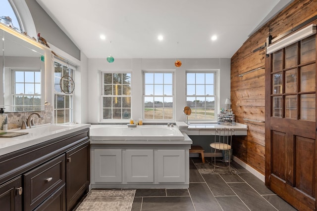 bathroom featuring tasteful backsplash, tile patterned flooring, lofted ceiling, a bathing tub, and wood walls