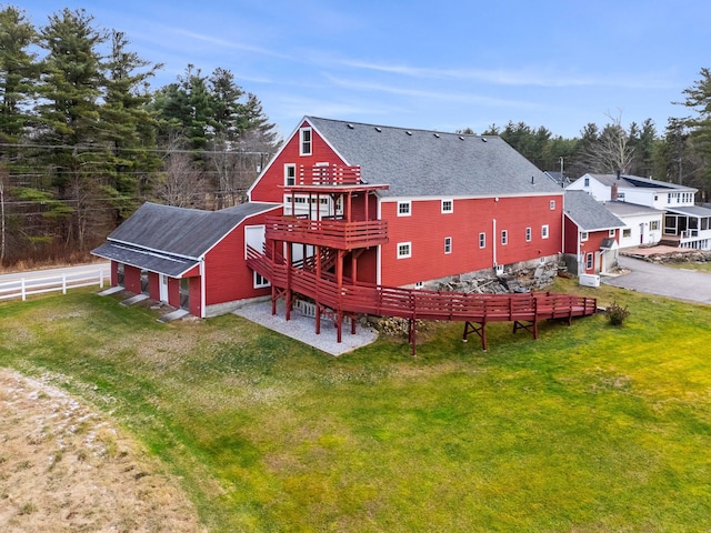 rear view of property featuring a lawn