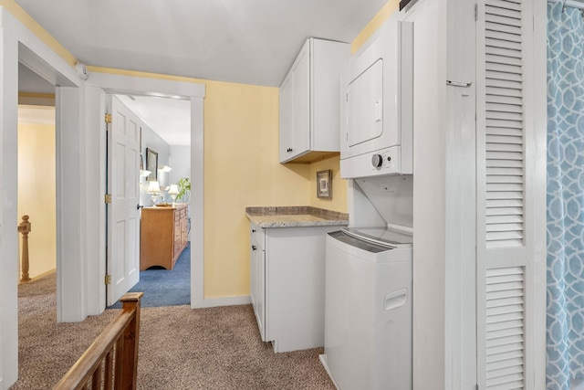 washroom featuring light carpet, cabinets, and stacked washer and clothes dryer