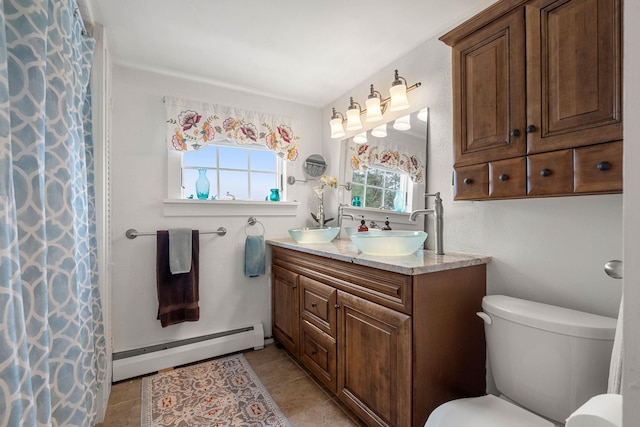 bathroom with baseboard heating, tile patterned flooring, vanity, and toilet