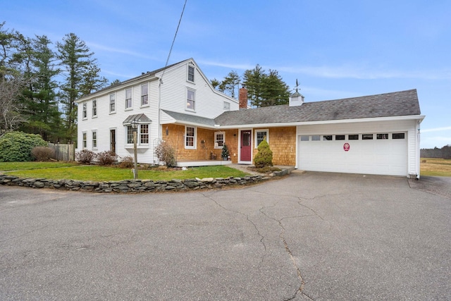 view of front of property featuring a front lawn and a garage