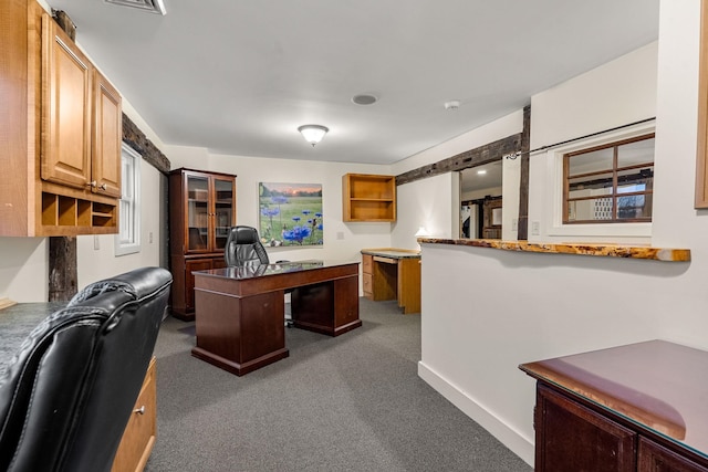 office area with dark carpet and a barn door