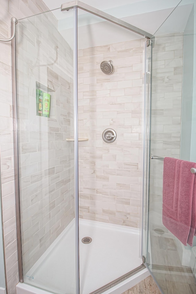 bathroom featuring a shower with door