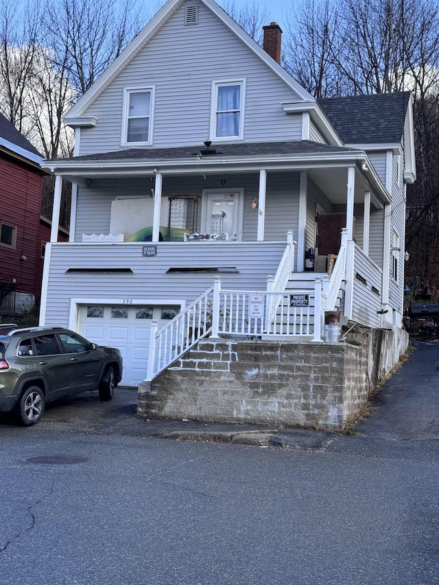 view of front facade featuring a porch and a garage