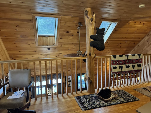 interior space featuring wood-type flooring, wooden ceiling, a healthy amount of sunlight, and wood walls