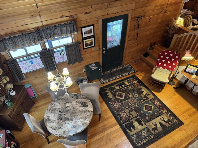 living room with wooden ceiling, light hardwood / wood-style flooring, and wooden walls