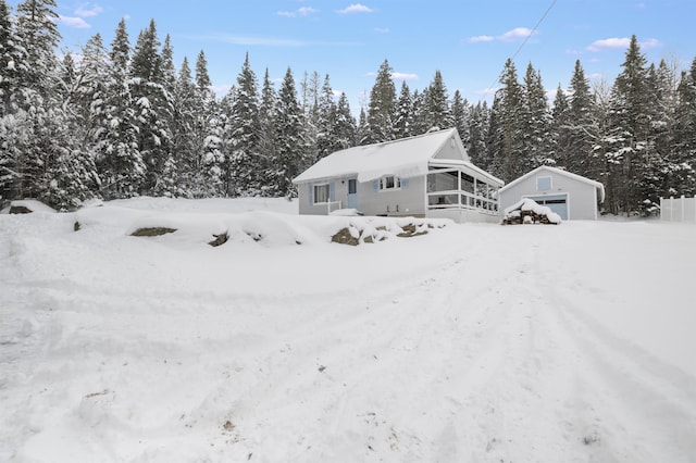 exterior space with a garage and an outbuilding