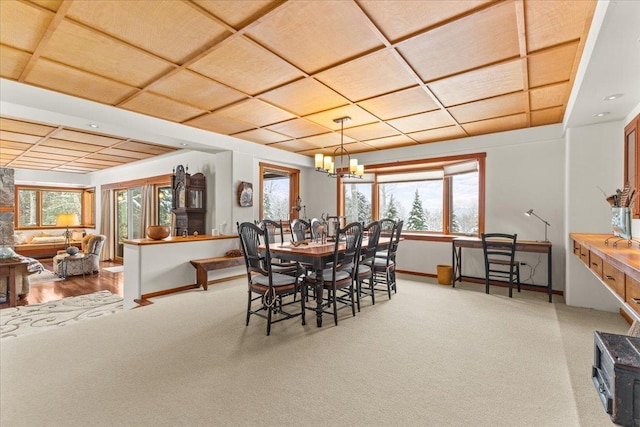 dining space with carpet flooring and a notable chandelier