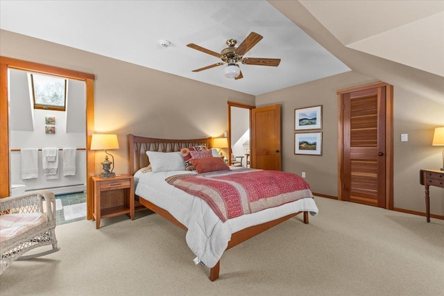 carpeted bedroom featuring a baseboard radiator and ceiling fan