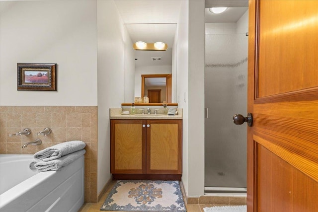 bathroom with tile patterned floors, vanity, separate shower and tub, and tile walls