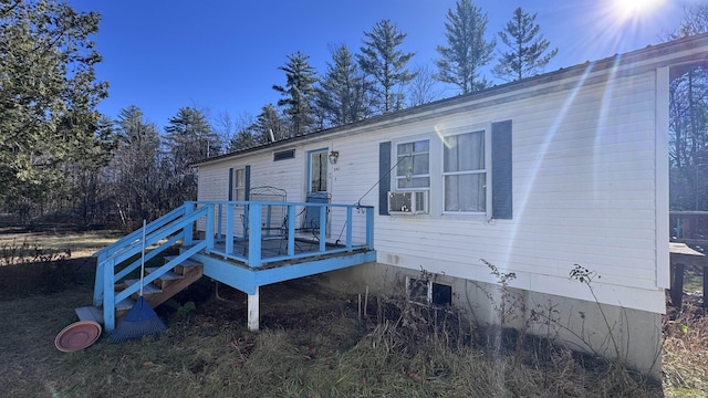 rear view of house featuring a wooden deck