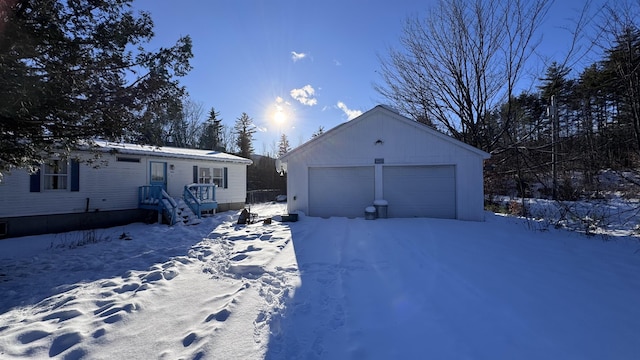 view of front of home with a garage and an outdoor structure