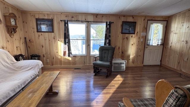 sitting room featuring plenty of natural light and wooden walls