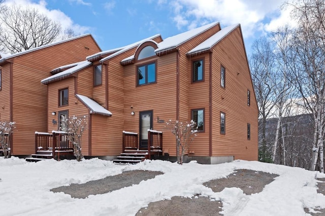 view of snow covered rear of property