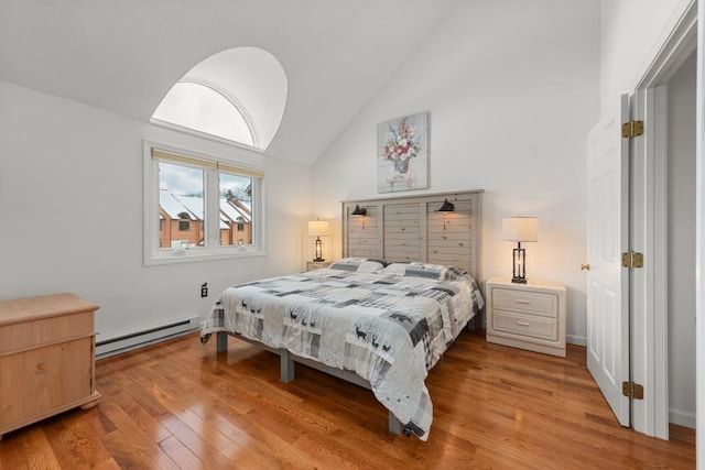 bedroom featuring high vaulted ceiling, a baseboard radiator, and hardwood / wood-style flooring