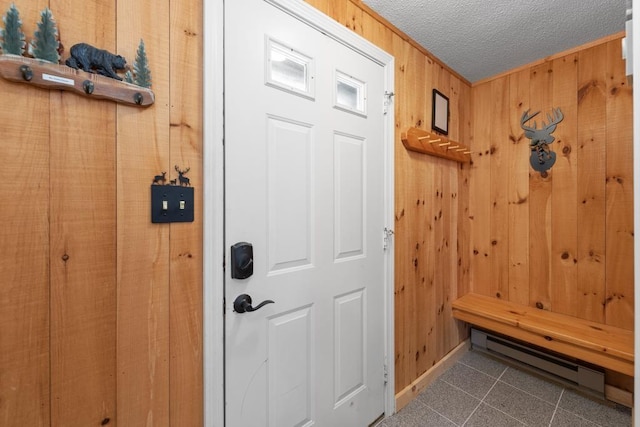 mudroom featuring tile patterned flooring and wood walls