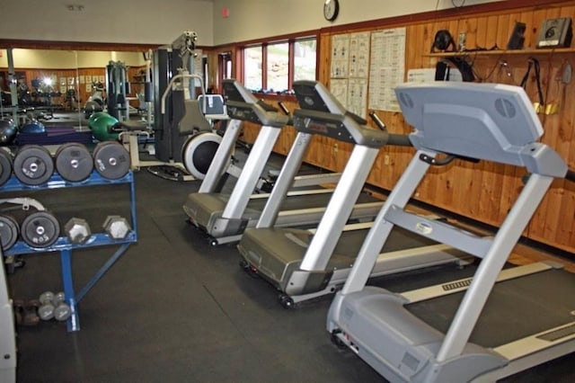 exercise room with wood walls