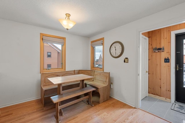 dining area featuring light hardwood / wood-style floors and a textured ceiling