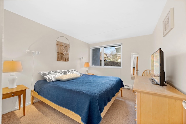 bedroom with light carpet and a baseboard radiator