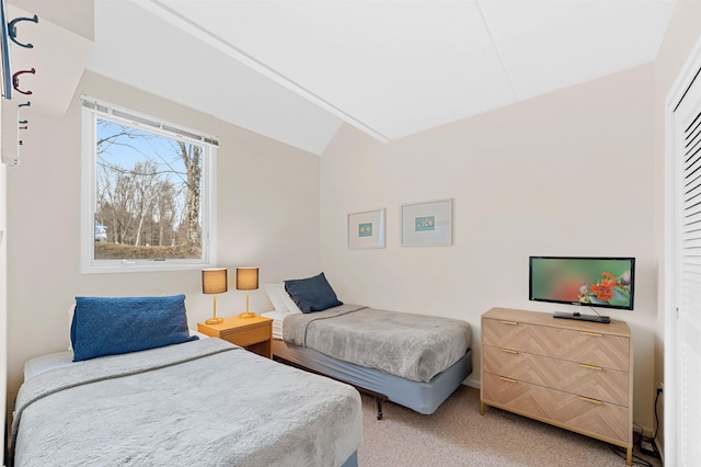 bedroom with carpet floors and vaulted ceiling