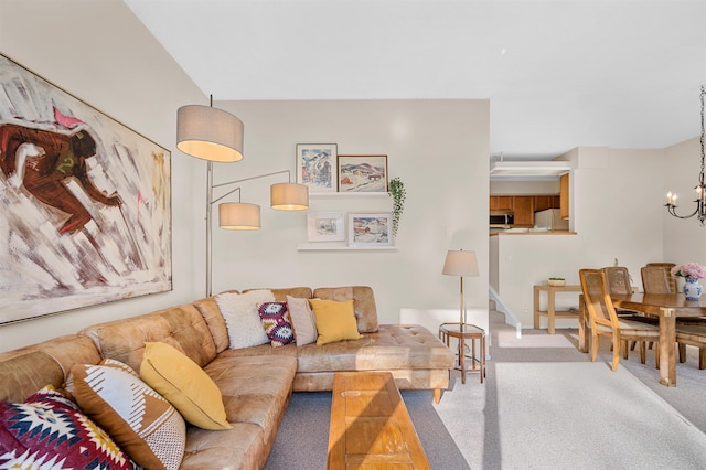 living room with carpet floors and a notable chandelier