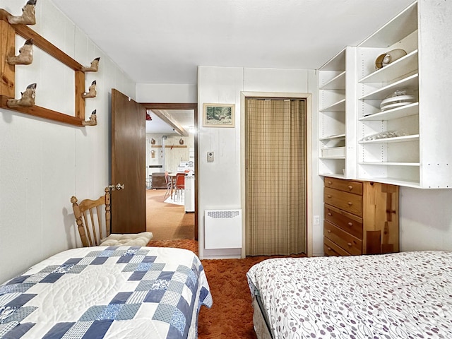 carpeted bedroom with wood walls