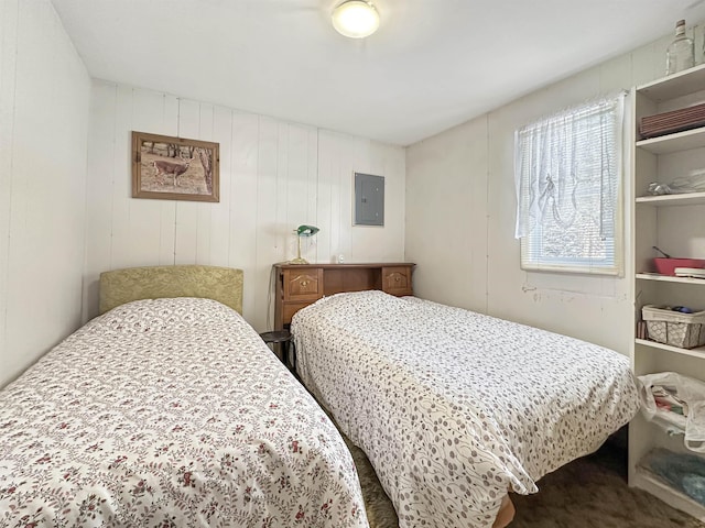 carpeted bedroom with electric panel and wooden walls