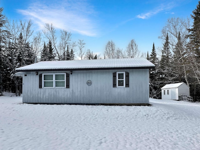 view of front of home with a shed