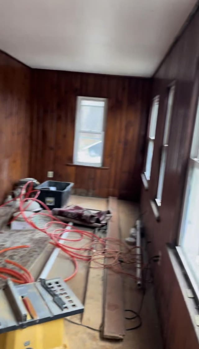 bedroom featuring wood walls