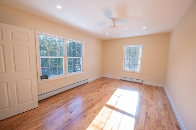 empty room with ceiling fan, light hardwood / wood-style flooring, and a baseboard radiator